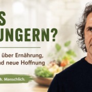 René Gräber vor gesunden Lebensmitteln und stilisierter Krebszelle – Jane McLellands Ansatz „Krebs aushungern?“